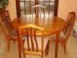 Round extending dining table and 4 chairs. Solid teak....
